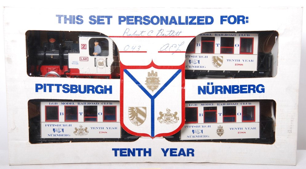 LGB Pittsburgh Nurnbeg limited set: LGB modern G scale 00041 Pittsburgh Nurnberg 10th year limited set in OB. Set includes 0-4-0 loco and three coaches. Set is C8-9 with very little if any run time. OB has some light wear and dirt.