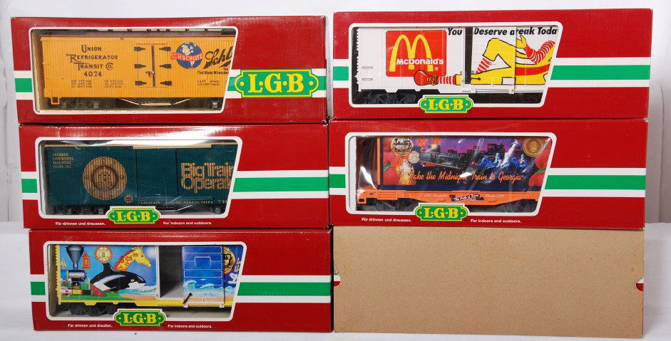 6 LGB freight cars 46675, 4074, 44910, etc: LGB modern G scale freight cars in OBs. Six cars include 46675 LGB reefer, 4074 Schlitz reefer, 44910 McDonalds boxcar, 44858 Georgia convention flat, 4069 LGB flat with containers, and 4091 San Diego