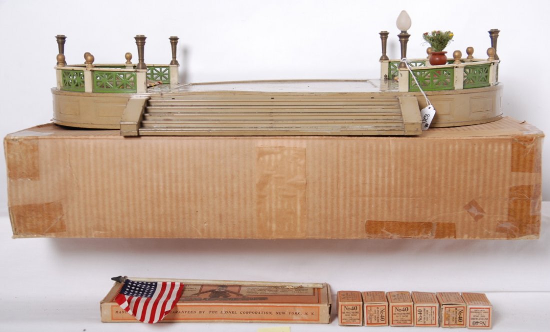 Lionel 129 terrace in original box with components: Prewar Lionel 129 terrace with plots, No. 90 flag staff in original box and six 40 globes in original boxes (one removed and installed for photos), all in original box, should clean and polish C5-6. 9