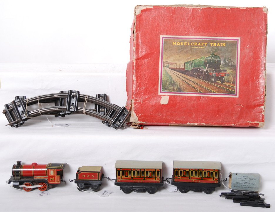 Modelcraft P S/56 passenger set clockwork O India: Postwar Modelcraft Train O gauge clockwork P S/56, made in India in original box. Set is comprised of 786 steam loco and MAS tender, and two 1st and 2nd class coaches. Loco has a little very light sur