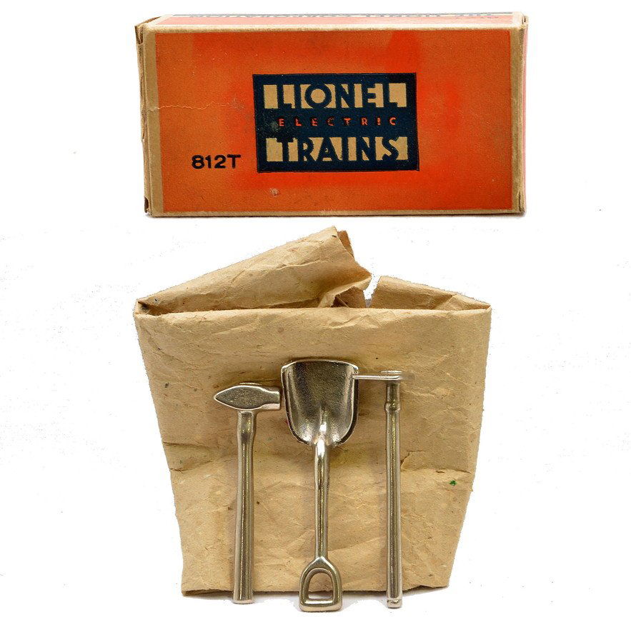 Lionel Prewar 812T Tool Set MINT Boxed: Lionel prewar O gauge 812T tool set in OB with original paper wrap. The set contains nickel plated cast iron tools including a hoe, shovel and sledge hammer. The tools are C9-10. The box has all flaps