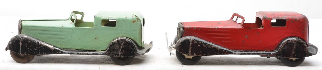Pressed Steel two Wind-Up Cars: Pressed steel wind-up cars, one red and black and the other one mint green and black, C5. The cars measures 6 inches in length.
