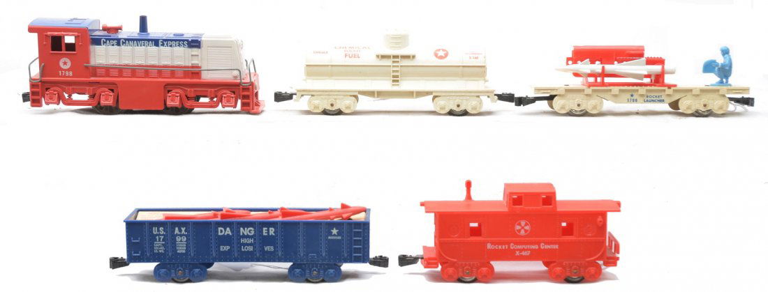 Marx Cape Canaveral Freight Train Set: Marx Cape Canaveral freight set consisting of a 1798 diesel, 1799 gondola with three red missiles and original cardboard insert, X246 chemical Rocket Fuel tank car with a crack in one end that has bee