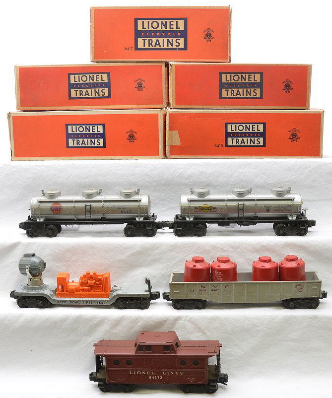 Lionel Freight Cars 6415 6417 6562 6425 3620 OBs: Lionel postwar freight cars including; 6562-1 gray New York Central gondola with four red plastic canisters, 6425 silver Gulf three dome tank, 3620 gray searchlight car with an orange generator, 6415
