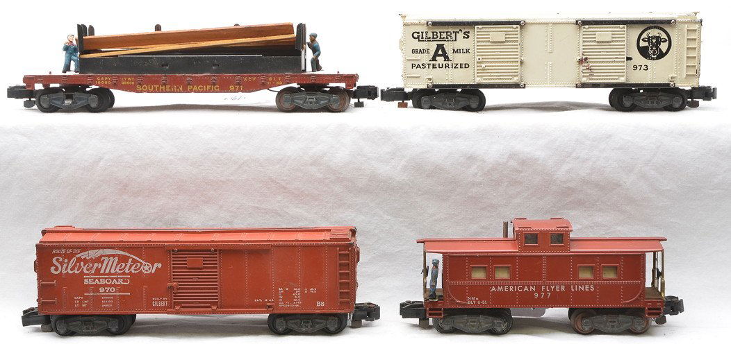 Am Flyer Freight Cars 970 971 973 977: American Flyer S gauge freight cars including; 970 Seaboard operating boxcar with a broken catwalk and missing the man, 971 Southern Pacific lumber unloading car, 973 Gilberts operating milk car and 9