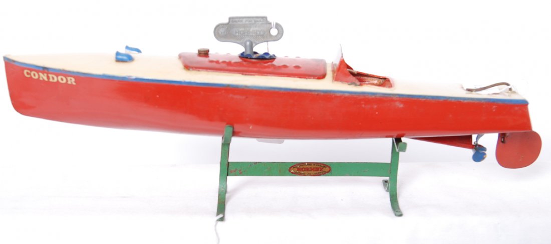 Hornby Speedboat Condor w/key on stand mechanical: Postwar Hornby Speedboat Condor with original key and stand. Mechanical windup boat has some wear to paint on motor cover and some rust on stand. Boat retains 95-98% original paint, C7 area. Motor wor