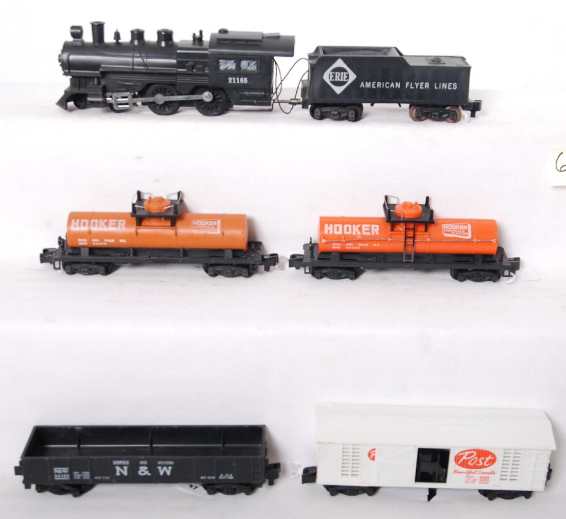 American Flyer 21165, 24103, 24329, etc: American Flyer postwar S gauge trains including 21165 Erie steam locomotive, two 24329 Hooker tank cars one missing ladders, C2001 Post hay thrower boxcar, and 24103 Norfolk and Western gondola. Train