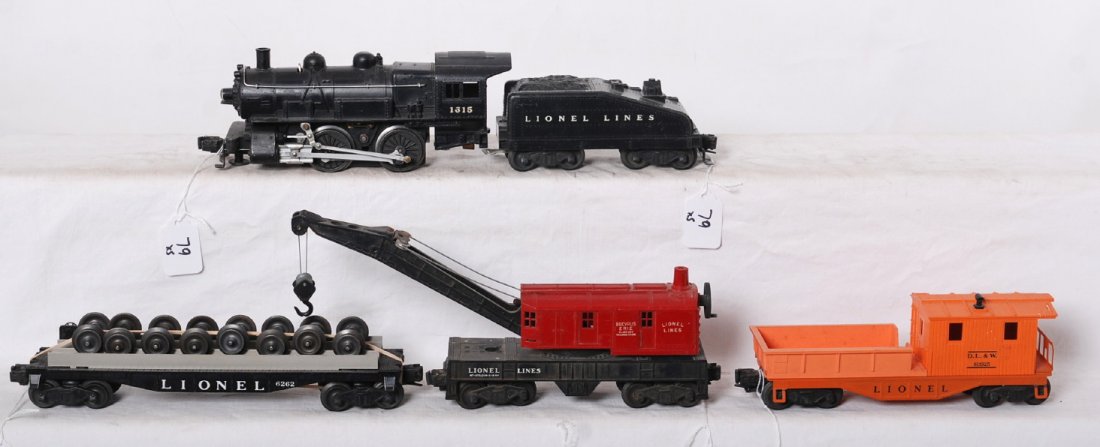 Lionel 1615, 6262, Erie crane, 6119-25: Lionel Postwar O gauge trains including 1615 steam locomotive with partially repainted shell and Lionel Lines tender, 6119-25 DL&W work caboose, Erie crane missing numbers, and 6262 flat with wheels. 