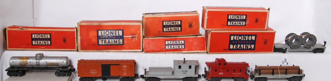 Lionel 3464, 6561, 6411, 2555, 6357, 6419 in OB: Postwar Lionel O gauge freight cars in original boxes, 3464 New York Central operating boxcar, 6561 cable reel car with gray reels, 6411 flatcar with logs, 2555 Sunoco tank, 6357 SP caboose, and 6419 