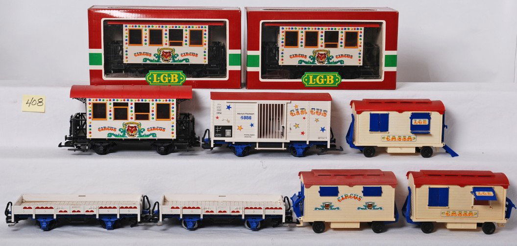 6 LGB Circus freight cars 3036, 4036, etc: LGB modern G scale Circus freight cars. Six cars include three 3036 passenger cars one without box, two flats with wagon, one extra wagon, and 4036 animal wagon with a few cracked bars. Cars are C7 to