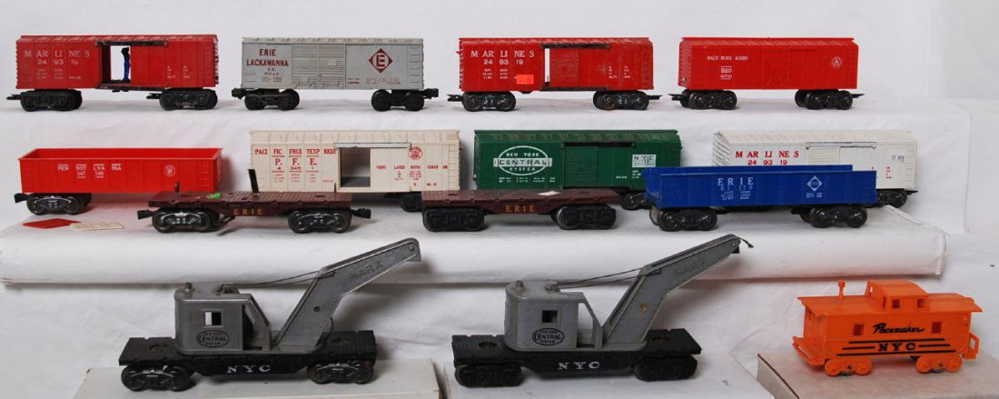 Fourteen Marx O gauge freight cars, some operating: Postwar Marx O gauge freight cars with loose door guides, cracked shells, rust, etc. Three 249319 Marlines boxcars (one is white, two red), 467110 B&O boxcar, 9043 Erie Lackawanna boxcar, 17693 NYC bo