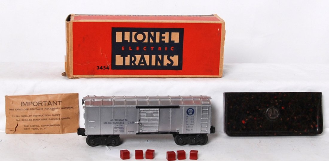 Lionel 3454 Automatic Merchandise car in OB w/comp.: Postwar Lionel O gauge 3454 Pennsylvania Automatic Merchandise car in original box with 160 bin, six tougher red Baby Ruth crates, and 3454-51 envelope. Boxcar looks C7-8. Box has tape repairs, missin