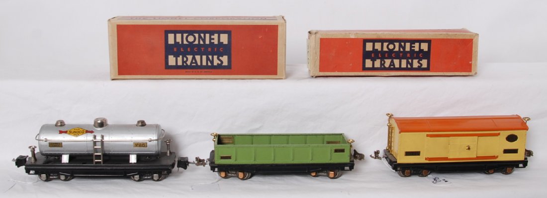 Lionel 812 in OB, 814, 815 in OB: Prewar Lionel O gauge 812 gondola in apple green with brass plates, brake wheels, and copper journals in original box. 814 boxcar with yellow body, orange roof and door guides with brass name plates, 