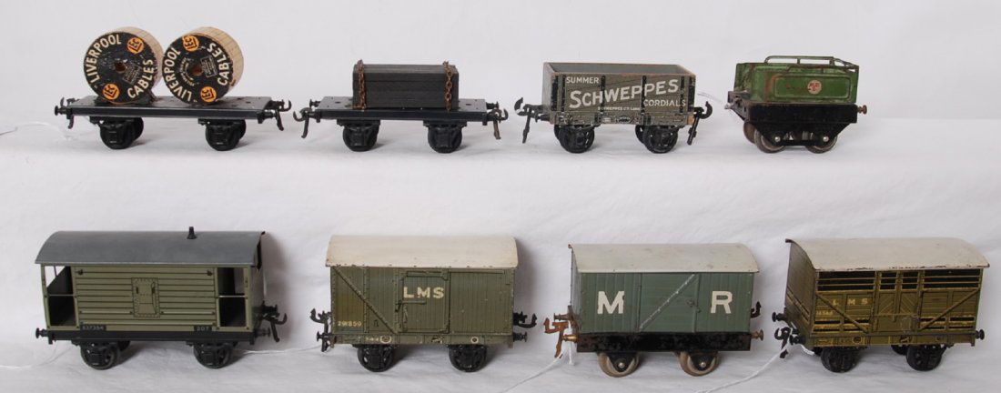 Basset Lowke freight cars: Basset Lowke O gauge freight cars and a tender. 291859 LMS goods wagon is missing a coupler latch, tender is missing rear coupler. Trains look C6 area. Also included is a tinplate tender with embossed