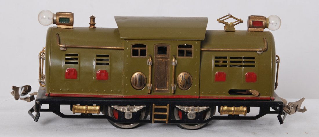 Lionel 254 electric center cab loco, factory error: Prewar Lionel O gauge 254 center cab electric locomotive with dings in roof, repainted to look C7 area. Interestingly shell is a factory error with too many louvers stamped on one end of both sides of