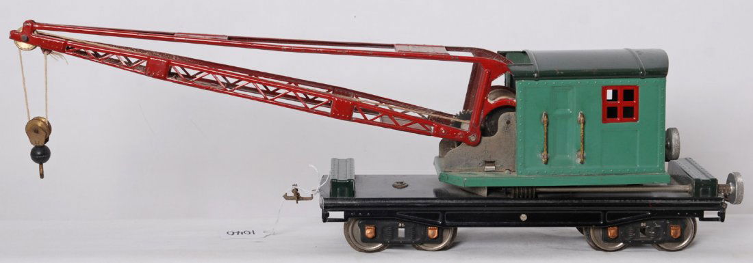 Lionel 219 operating derrick crane, mixed trim: Prewar Lionel standard gauge 219 operating derrick crane in peacock cab, green roof and tool boxes, with red windows and boom, on black frame. Brass plates, aluminum knobs, cooper journals. Wheels hav