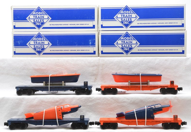 Lionel 2-Flatcars w/Boats 2-Flatcars w/Airplanes: Model Train Sales Inc. orange flatcar with boat that has orange hull and blue deck, blue flatcar with boat that has blue hull and orange deck, orange flatcar with blue over orange airplane and a blue 