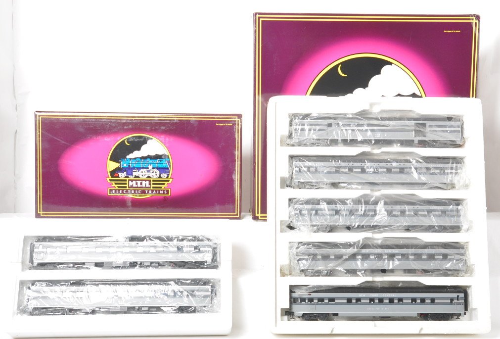 MTH NYC 7 car streamlined passenger set: MTH modern O gauge New York Central 70 foot streamlined passenger cars in OBs. Seven cars total. Includes 20-6554 five car set and 20-6554 sleeper / diner add on set. Cars are C8 with run time. OBs ha