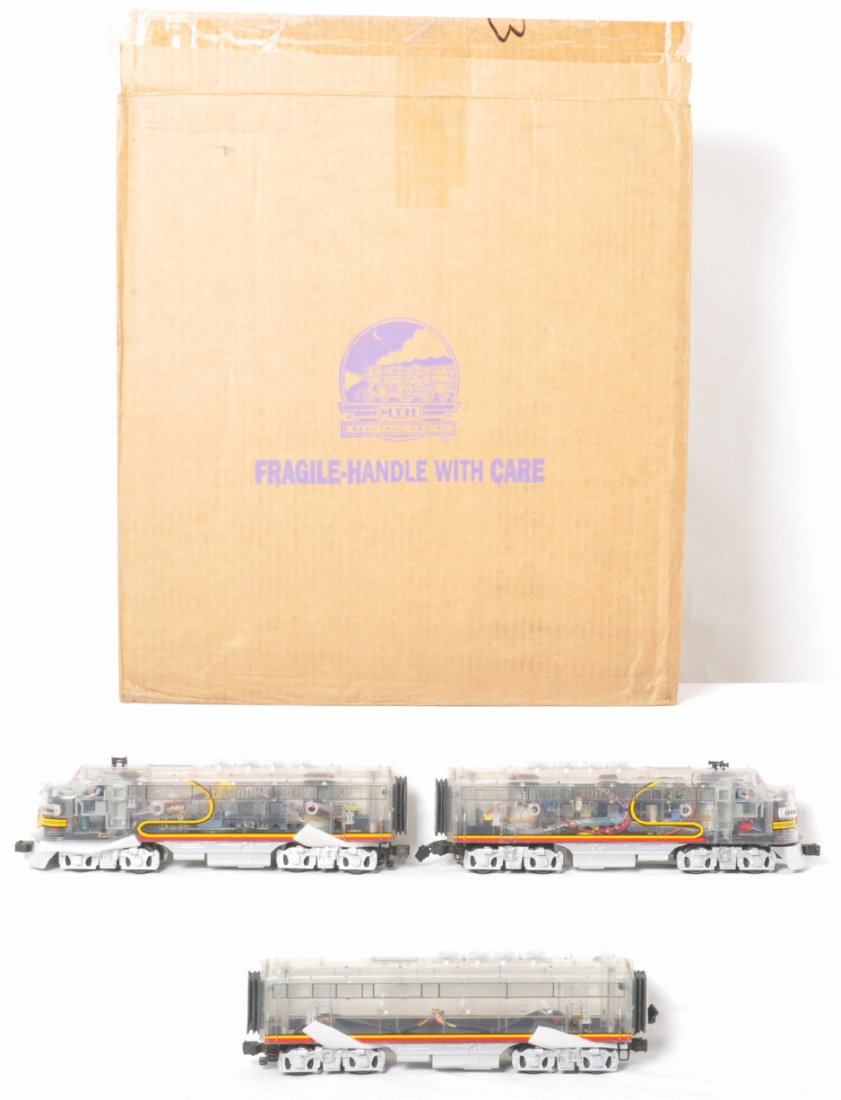 MTH DAP clear shell Santa Fe F3 A-B-A: MTH modern O Gauge Dealer Appreciation Program clear shell Santa Fe F3s in OBs. Catalog number is 20-80002A. Locos feature Protosound and Protocouplers. Locos are C8+ with some light run time.