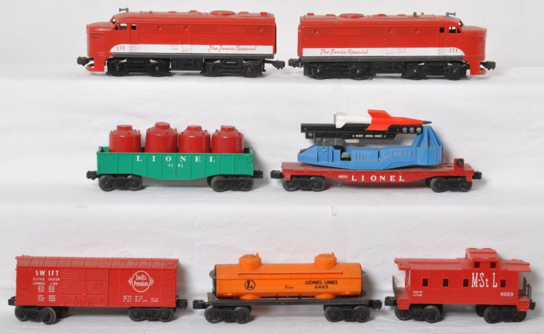 Lionel 211 P&T, 6050, 6465, 6142, 6650, and 6059: Postwar Lionel O gauge 211P and 211T MKT The Texas Special Alco diesel A units (powered unit has repaired pilot), 6050 Swift boxcar with coin slot, 6465 tank, 6142 gondola with four red canisters, 665
