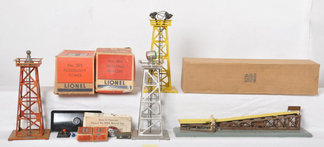 Lionel 362, 394, 395, 494, and components... in OB: Postwar Lionel O gauge accessories, some in original boxes, and some components. 362 barrel loader in OB, broken section of fence. 394 beacon, heavily faded. 395 floodlight tower, C8-9 tower with inst