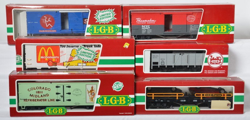 6 LGB freight cars 4059, 4491, 4090, 4072, etc: LGB modern G scale freight cars in OBs. Six cars include 4059 flat with autos, 41213 BEG gondola, 4491 McDonalds boxcar, 4072 P 02 Colorado Midland refrigerator car, 4090 VW boxcar marked in incorrect
