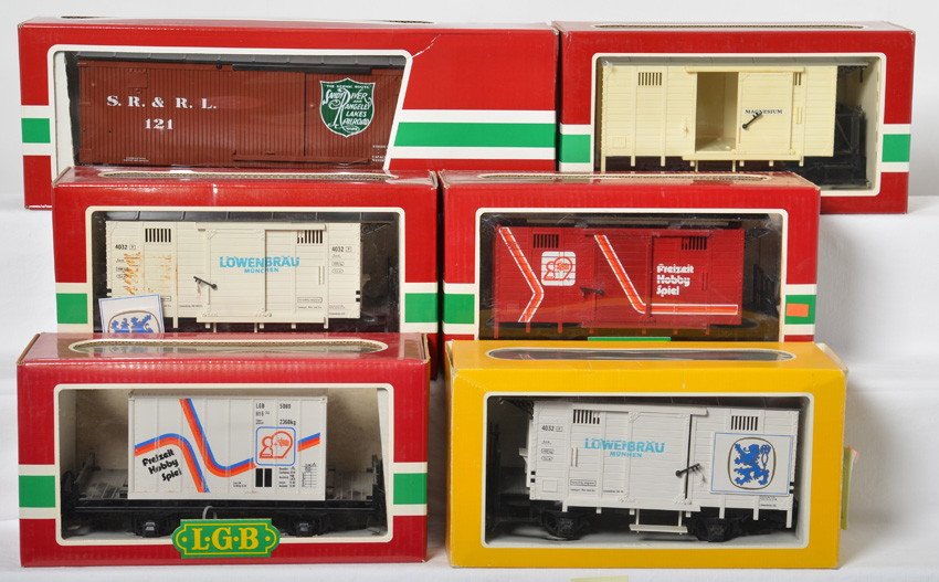6 LGB freight cars 4032L, 4031CL, 4002, 48670, 4031: LGB modern G scale freight cars in OBs. Six cars include two 4032L Lowenbrau beer boxcars one with detached emblem, 4031 FHS Freizeit Hobby boxcar, 48670 Sandy River boxcar, 4002-69 Freizeit hobby con