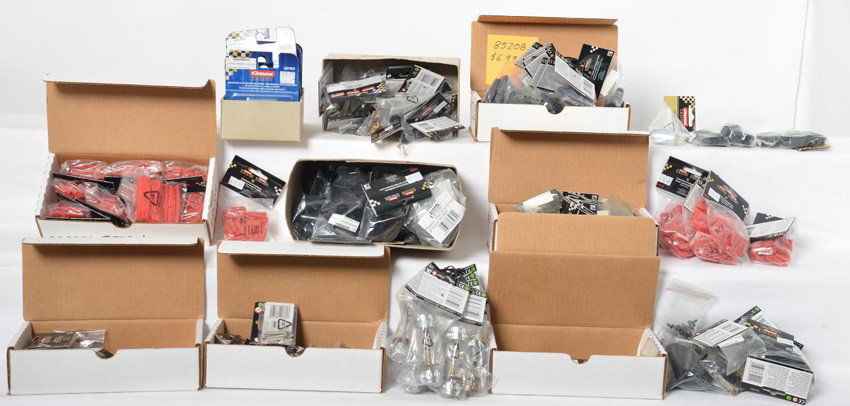 Carrera decoders, axles, brushes, etc: Large group of Carrera slot car parts. Includes eight 20763 decoders, eleven 83000 series axles, two 83045 tire sets, ten 85202 high banked curve supports, box full of new brushes and parts, seven bag