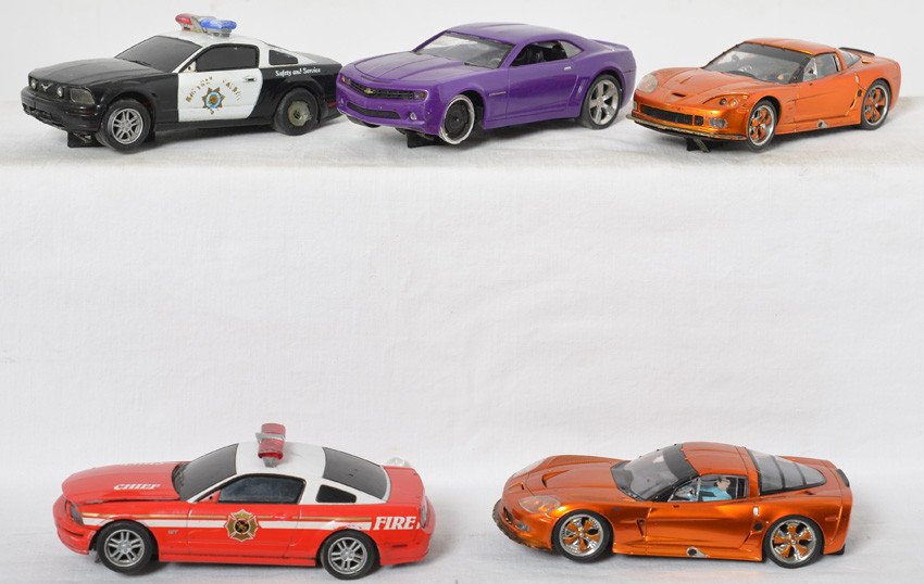 5 Carrera slot cars Mustang, Corvette, etc: Carrera slot cars. Five cars including two Corvettes, two Mustangs, and Camaro. All have been raced and have light body wear. Sold as is.