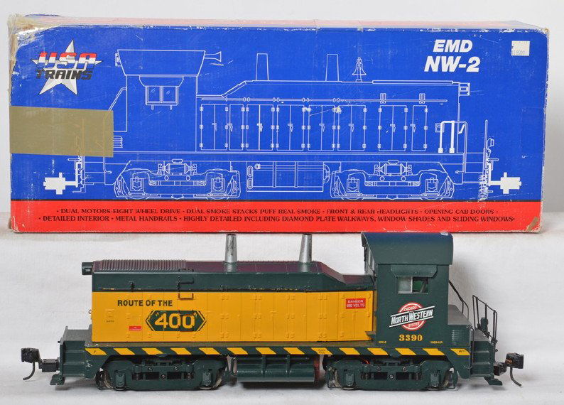 USA Trains C&NW NW2 switcher: USA Trains modern G scale 22013 Chicago and Northwestern NW2 switcher in OB. Box is marked with having Loco Link. Switcher is C6-7 with some broken hand rails and light paint wear. OB is worn at corne