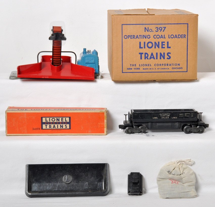 Lionel 397 coal loader in OB w/3469X dump in OB: Postwar Lionel O gauge 397 operating coal loader in original box with 364C control switch, repro bag of artificial coal, 160 bin, C6+. OB is C9. 3469X automatic dump car in original box missing flaps,