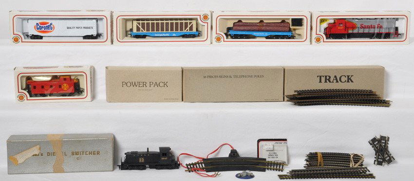HO locos, cars and more: Group of HO items. Includes older Santa Fe switcher with incorrect Tenshodo box, Bachmann Santa Fe GP-40, four Bachmann freight cars, transformer, track, and a few telephone poles. See photos for best