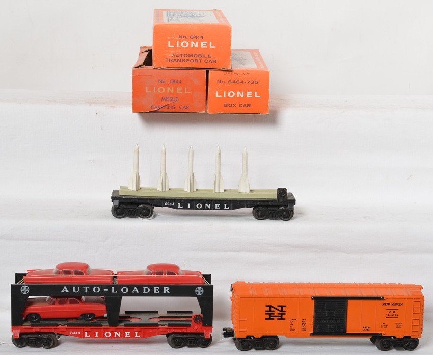 Lionel 6414, 6844, 6464-735 freight in OB: Postwar Lionel O gauge 6414 Evans Auto-Loader with three red autos with gray bumpers, 6844 missile carrying car (missing one rocket and mount), and 6464-725 New Haven (correct -735 OB) missing a coupl
