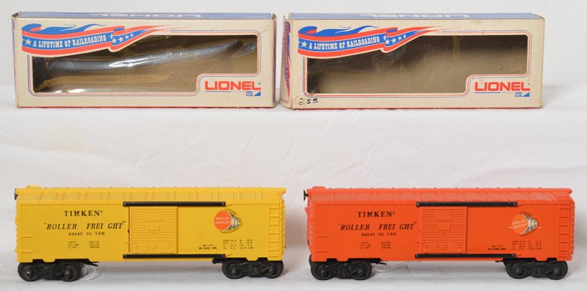 Lionel 6464-500 Timken in OB, yellow & orange: Modern era Lionel O gauge 6464-500 Timken Roller Freight boxcars in original boxes. Orange boxcar has a touchup on a roof corner, otherwise unrun C9-10. Yellow boxcar looks unrun C9-10. One box is mis
