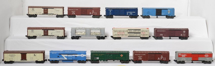 Thirteen Lionel boxcars, reefers, milk cars, etc.: Postwar Lionel O gauge freight cars. Trains should clean and polish C6-7 area. 6572 REA reefer, 3484 PRR, 6376 circus, 6464-50 M&St.L., 6468 B&O, 6464-475 B&M, 3494 NYC, 3662 milk car, two 6672 SFRD r