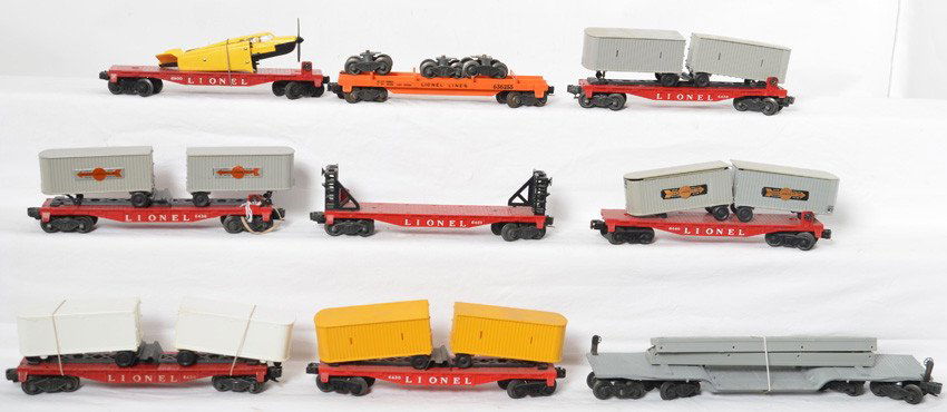 9 Lionel cars 6430, 6800, 6440, 6418, 6362, 6467, etc: Lionel Postwar O gauge freight cars. Includes 6418 machinery car with bridge girders, four 6430 flats with different trailer loads one broken step noted, 6800 flat with original yellow and black bonan