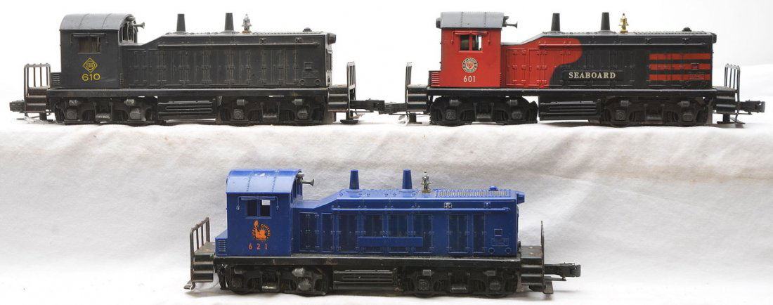 Lionel NW2 Switchers 601 Seaboard 610 Erie 621 JC: Lionel postwar NW2 switchers; 601 Seaboard, 610 Erie and a 621 Jersey Central. The 621 has a broken coupler which is included. All cabs are cracked and all frames have rust. Please view photo to verif