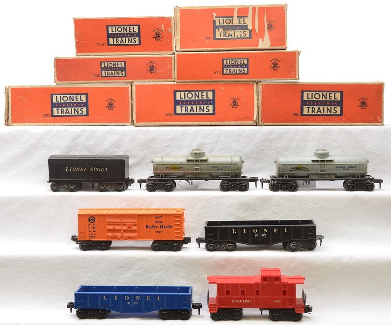 Lionel Scout 1001T 2-1002 2-1005 1004 1007: Lionel postwar Scout freight cars all in worn OBs including; 1001T tender, two 1002 gondolas, one blue and one black, two 1005 gray Sunoco tanks, 1004 orange Baby Ruth boxcar with a PRR logo and a 100