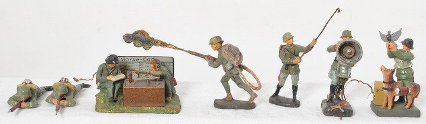 Group of Elastolin German composition key pieces: Vintage Elastolin German composition (masse) toy soldiers. Morse code operators, operating searchlight, soldier releasing message carrying pigeon and dog, flame thrower, soldier with cable reel on bac