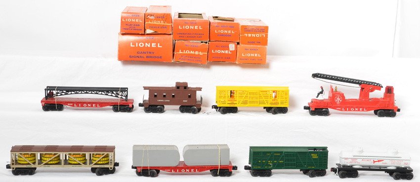 Lionel postwar freight cars and 452 in OB, 3512,: Postwar Lionel O gauge freight cars in original boxes, 3370 animated sheriff and outlaw, 3512 fireman and ladder car (missing one ladder section), 6440 flatcar w/piggy back vans, 6463 rocket fuel tank