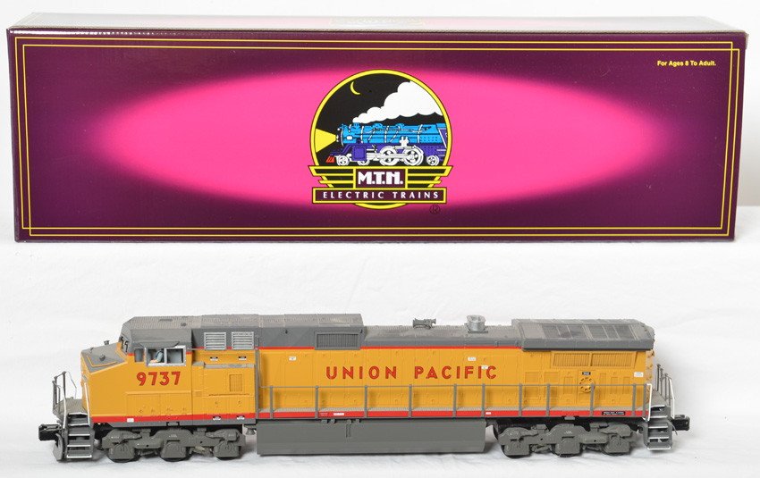 MTH Union Pacific Dash 9 with Proto 2: MTH modern O gauge 20-2270-1 Union Pacific Dash 9 diesel locomotive in OB. Loco features Protosound 2.0, DCS control, Protosmoke, Protocouplers, and more. Loco is C8+
