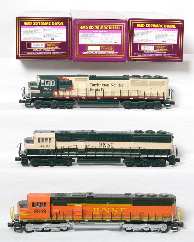 3 MTH BNSF SD70MAC locos with Proto: MTH modern O gauge BNSF SD70MAC diesel locomotives in OBs. All three locos feature Protosound, Protosmoke, Protocouplers, and more. Locos include 20-2215-1 Pumpkin, 20-2154-1 Eddie Bauer scheme, and 2