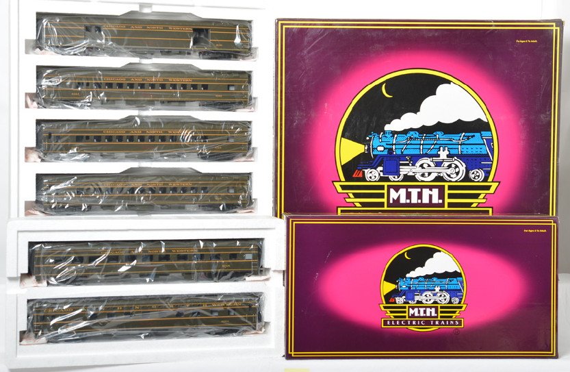 MTH Chicago and Northwestern 7 car passenger set: MTH modern O gauge Chicago and Northwestern seven car passenger set in OBs. Includes 20-6536 five car set and 20-6636 diner / sleeper add on. Cars are C9-10 with no major signs of run time. OBs have s