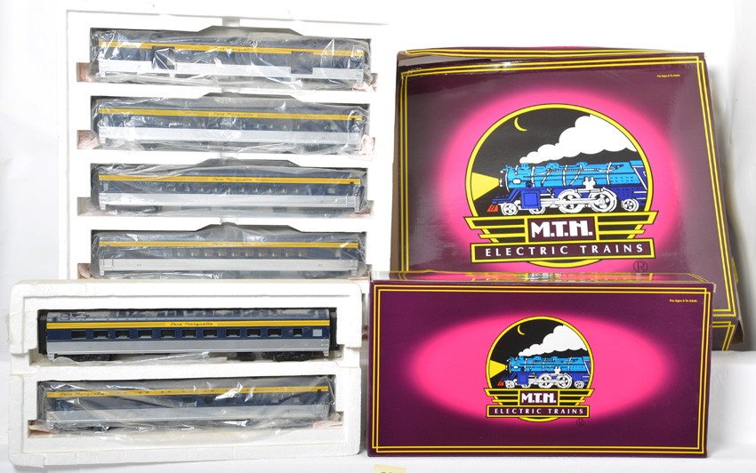 MTH Pere Marquette 7 car passenger set: MTH modern O gauge Pere Marquette seven car passenger set in OBs. Includes 20-6533 five car set and 20-6633 diner / sleeper add on. Cars are C8-9 with very light if any run time. OBs have some light s