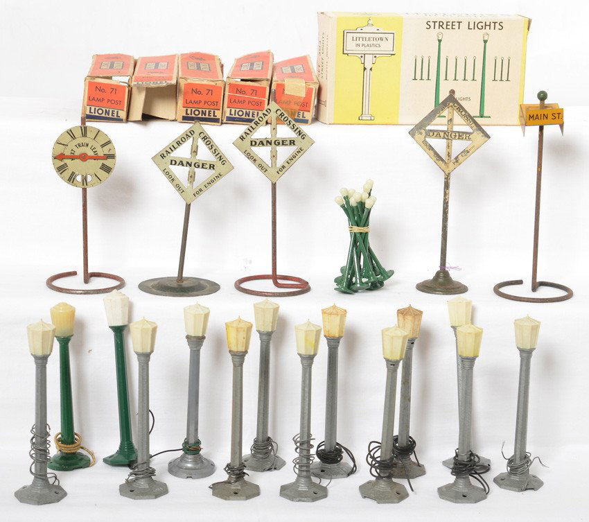 Grouping of lamps and signs, American Flyer, Lionel....: Nice grouping of prewar and postwar railroad signs, street sign, and various lamps. American Flyer, Ives, Lionel, Unlimited Plastics Corp., and Marx are probable manufacturers. C6 to C9-10 grouping. F