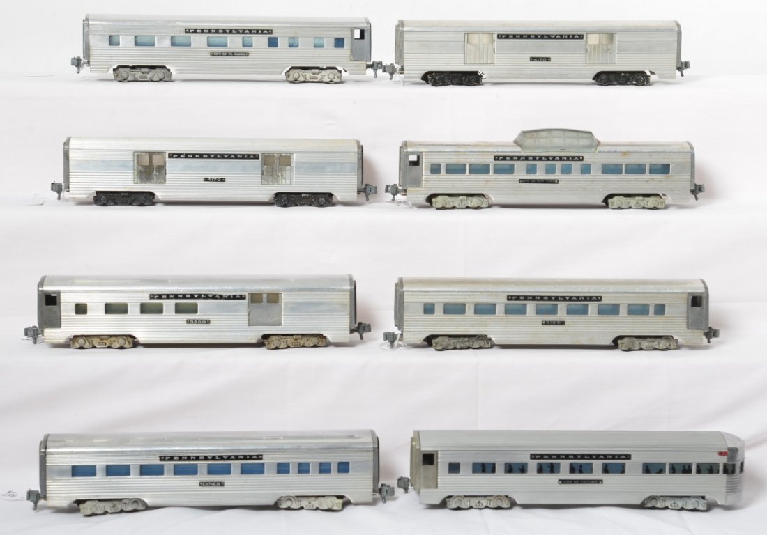 Eight AMT Pennsylvania aluminum passenger cars: Postwar American Model Toys O gauge Pennsylvania aluminum passenger cars, some are smooth and some ribbed, cars should clean and polish to look very nice C6 area. Diner, 3160 coach, 4170 baggage car (