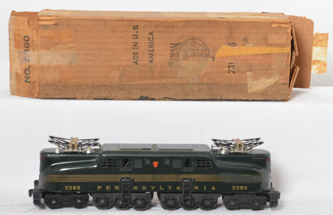 Lionel 2360 Pennsylvania 5-stripe GG-1 in OB: Postwar Lionel O gauge 2360 Pennsylvania 5-stripe GG-1 electric locomotive in original box, tiny touchups, otherwise C7 with very strong stripes. Box is square and solid with a torn and a missing oute