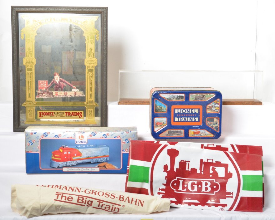 Lionel mirror, cookie jar, tin, LGB shopping bags, more: Modern era Lionel mirror, Enesco cookie jar in OB, empty collectors tin with oxidation and dented lid, four LGB shopping bags, display board with acrylic cover (28-3/8 inches long x 4-5/8 inches wide)