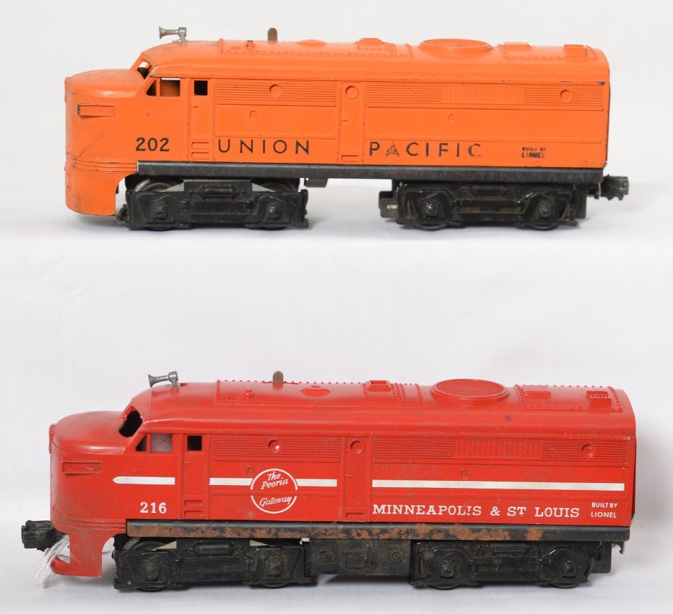 Lionel 202 U.P. and 216 M&St.L Alco diesel A: Postwar Lionel O gauge 202 Union Pacific and 216 Minneapolis and Saint Louis, diesel Alco A units. Hairline at slot on 202 and rust on 216 frame. Trains otherwise look C6.