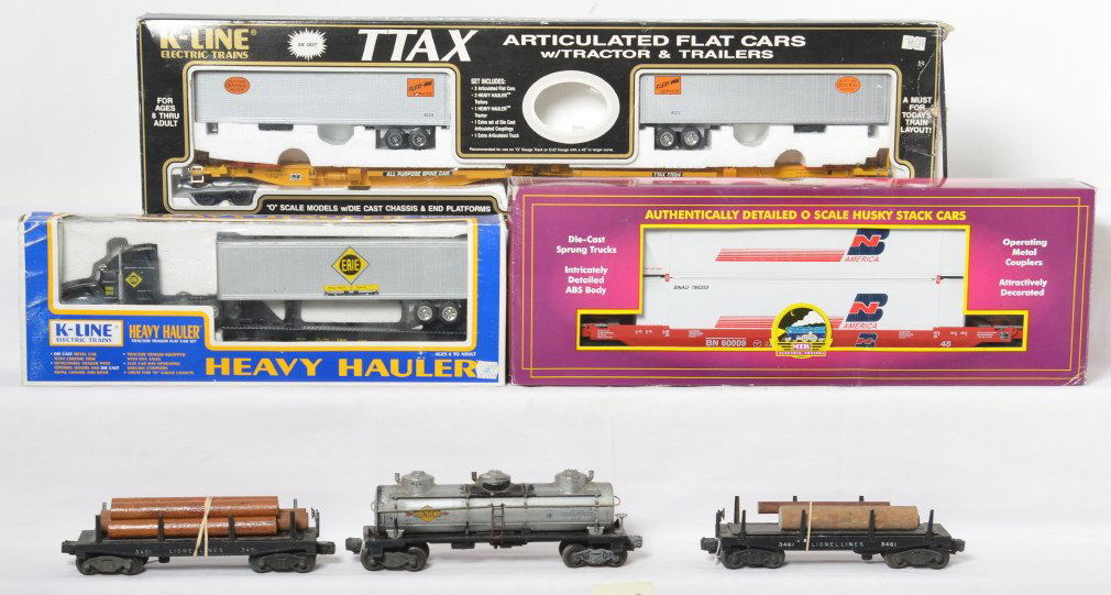 Postwar Lionel and modern MTH and K Line cars: Mix of O gauge trains postwar and modern. Postwar Lionel includes two 3451 log dump cars and 6415 Sunoco tank car C5 to C6. Modern includes MTH 9502L Burlington Northern husky stack, K Line Erie 6669